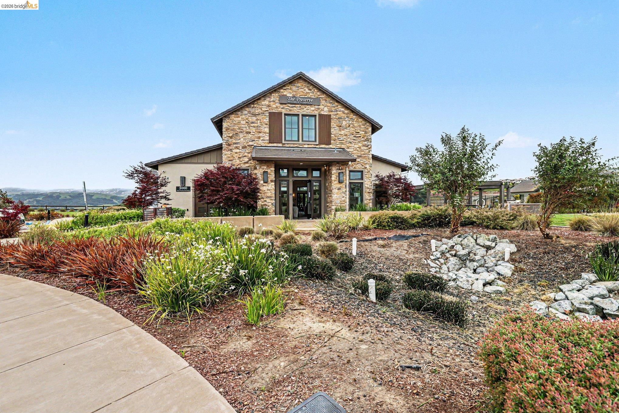 18210 Argento Loop San Ramon, CA 94583 - Photo 32 of 44 Stone facade building with dark window shutters, framed by varied landscaping