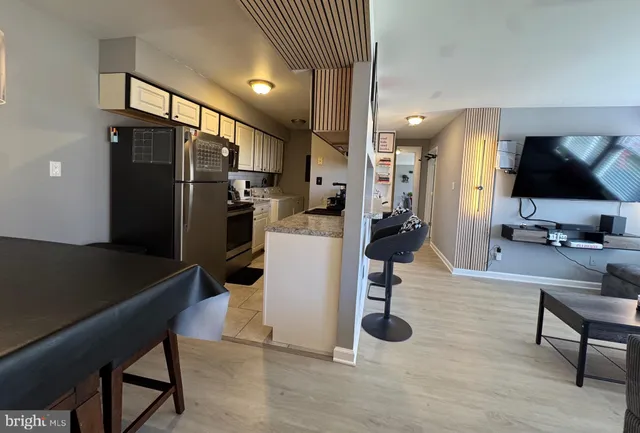 a kitchen with a refrigerator a stove and a sink