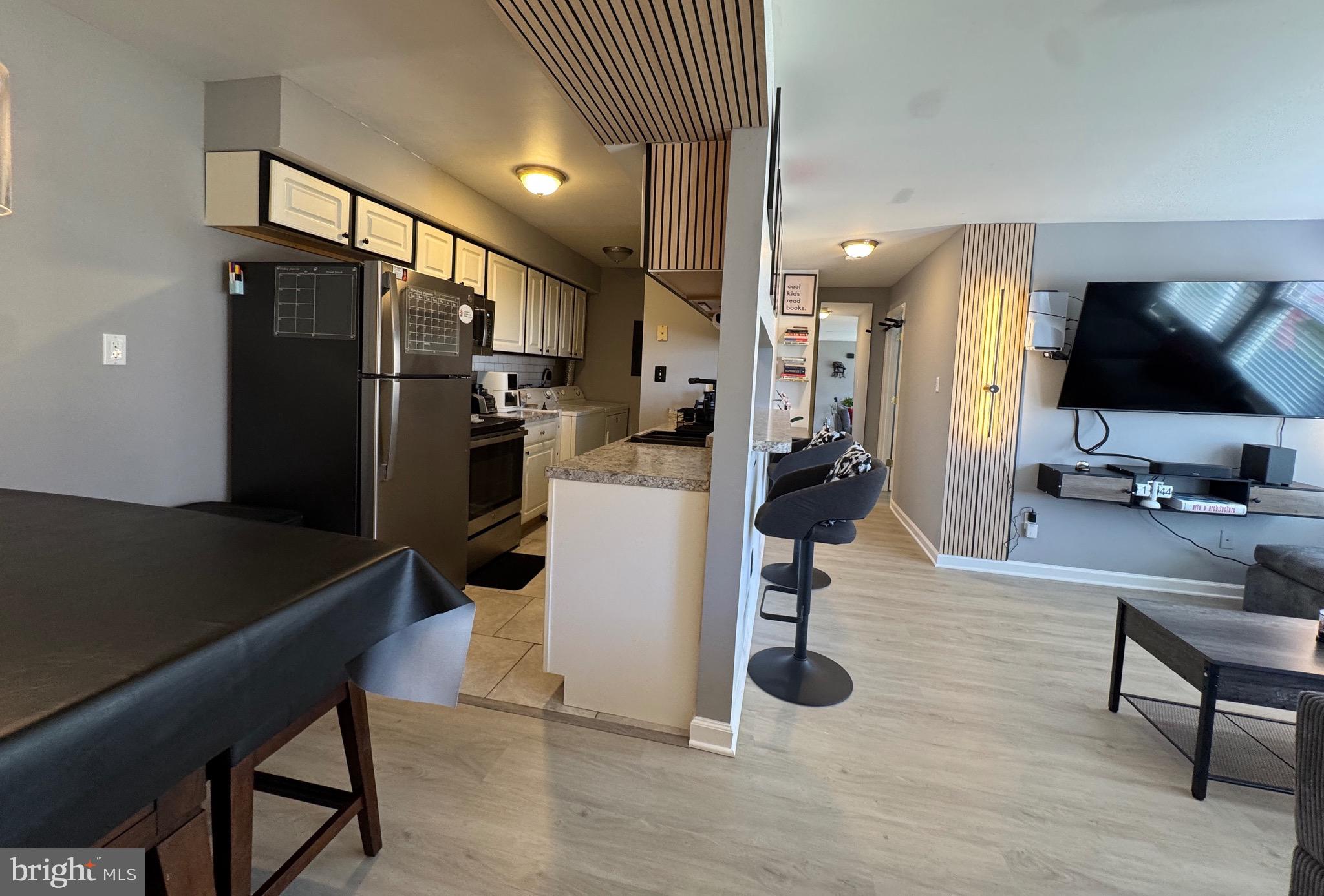 3079 Chester Grove Road, Unit 42E Upper Marlboro, MD 20774 - Photo 16 of 20 a kitchen with refrigerator and chairs