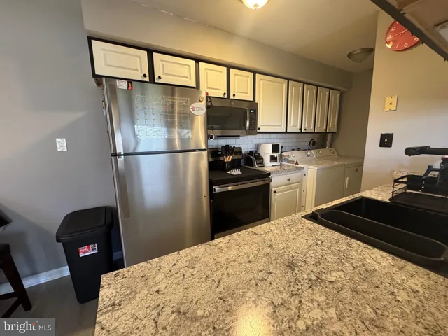 a kitchen with a table chairs stove and cabinets