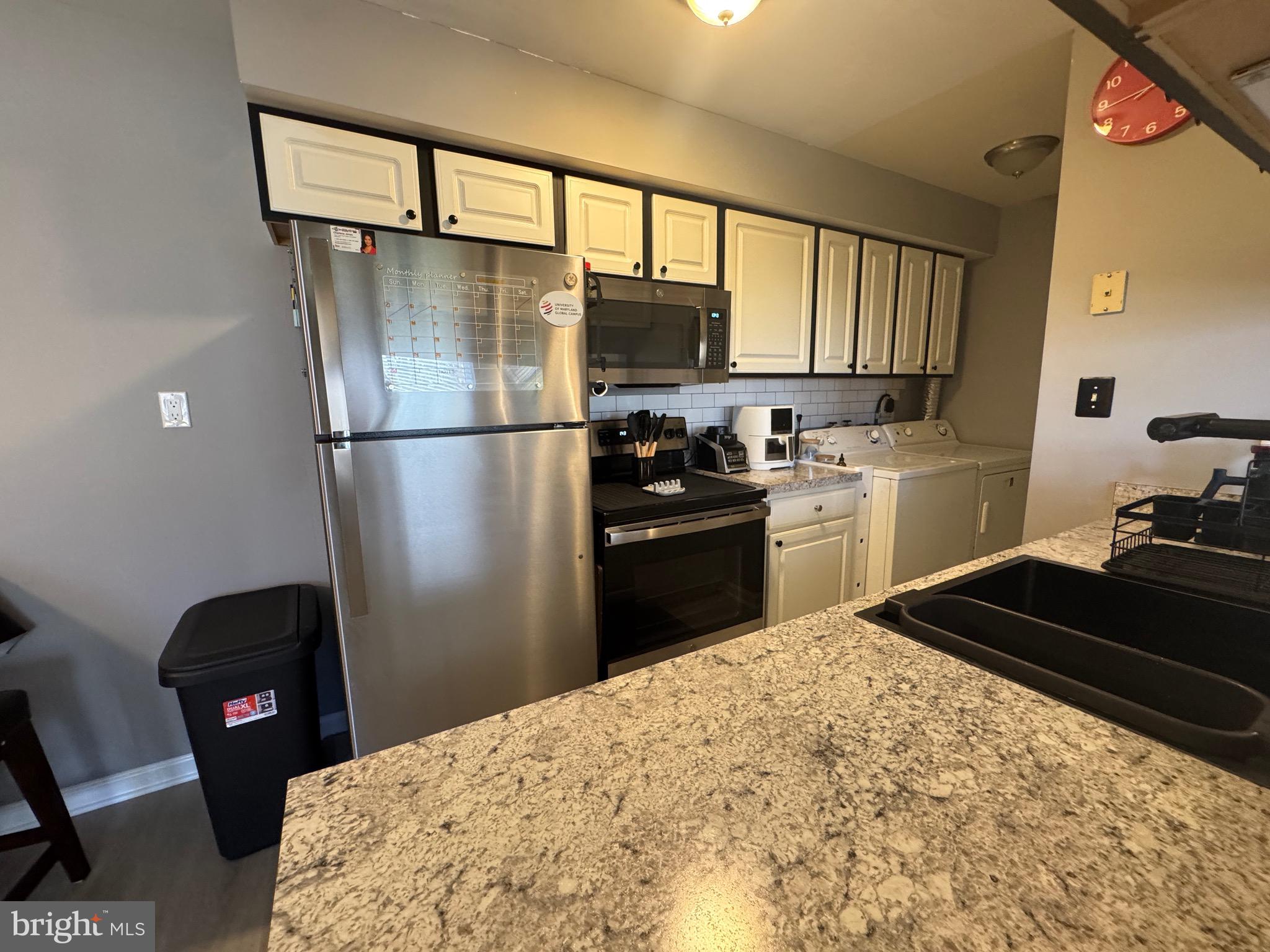 3079 Chester Grove Road, Unit 42E Upper Marlboro, MD 20774 - Photo 17 of 20 a kitchen with a refrigerator a stove and a sink