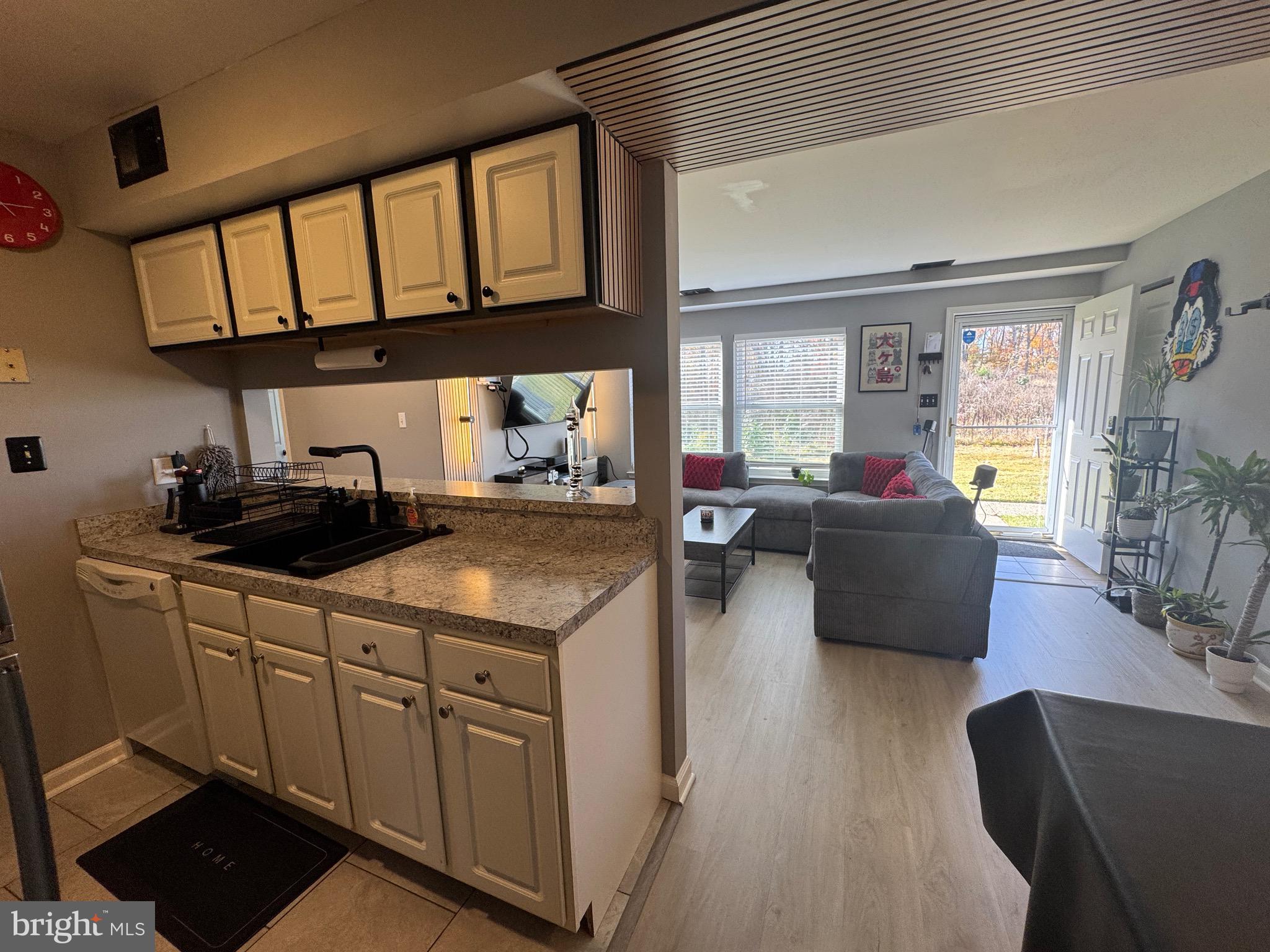 3079 Chester Grove Road, Unit 42E Upper Marlboro, MD 20774 - Photo 18 of 20 a kitchen with a table chairs stove and cabinets
