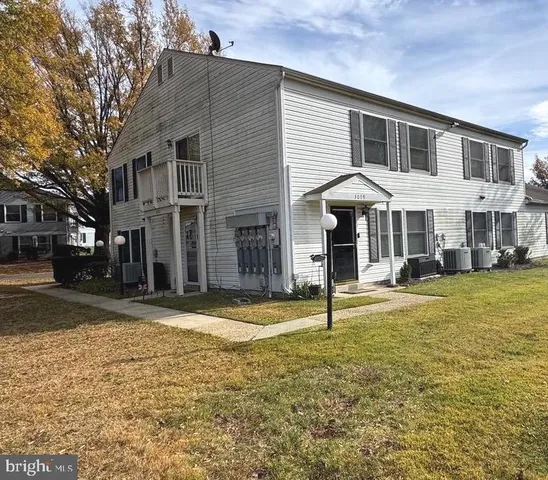 a front view of a house with a yard balcony