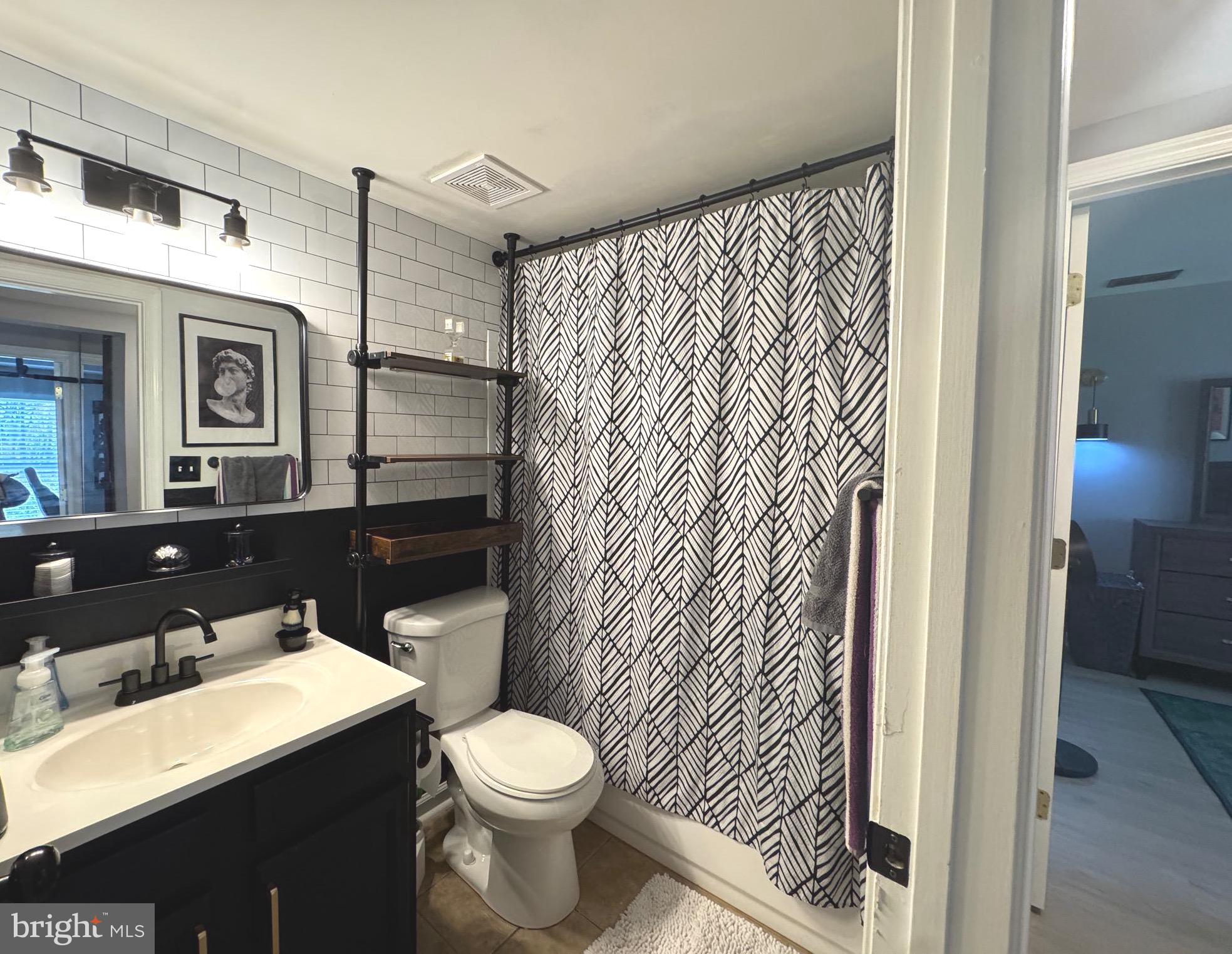 3079 Chester Grove Road, Unit 42E Upper Marlboro, MD 20774 - Photo 8 of 20 a bathroom with a sink a toilet and shower