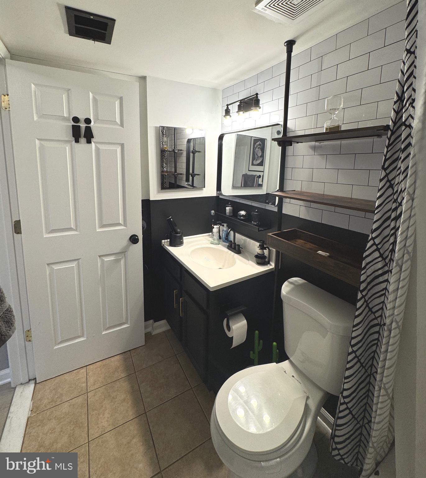 3079 Chester Grove Road, Unit 42E Upper Marlboro, MD 20774 - Photo 9 of 20 a bathroom with a toilet sink and mirror