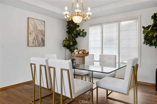 a living room with furniture a fireplace and a chandelier