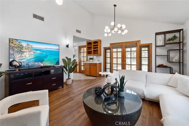 a kitchen with stainless steel appliances granite countertop a kitchen island a stove a dining table and chairs