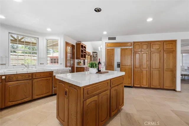 a kitchen with granite countertop stainless steel appliances a sink and cabinets