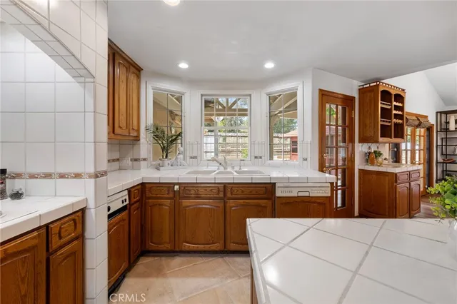 a spacious bedroom with a bed and a chandelier