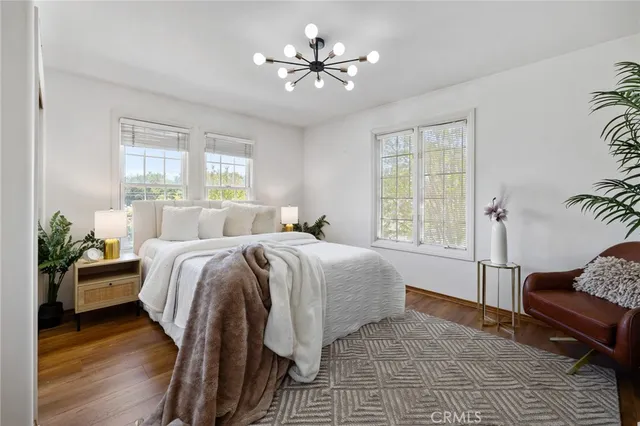a spacious bedroom with a bed and a chandelier