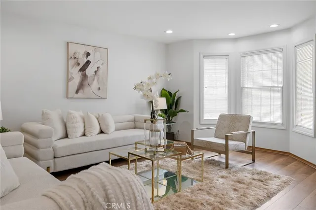 a dining room with furniture potted plants and wooden floor