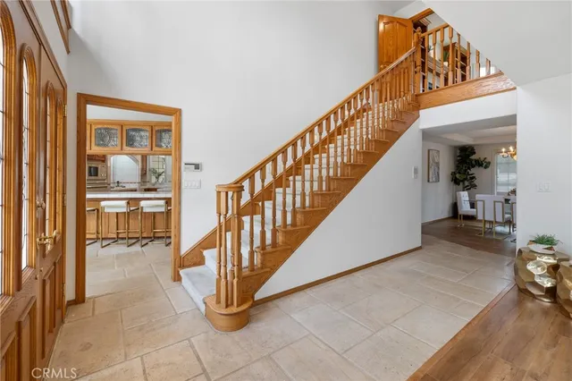 a view of a dining room with furniture and a chandelier