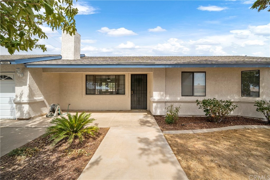 10883 Pinole Road Apple Valley, CA 92308 - Photo 1 of 1 a front view of a house with a garden