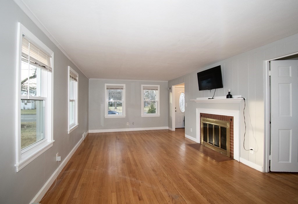 1617 Plumtree Road Springfield, MA 01119 - Photo 11 of 25 a view of empty room with fireplace and wooden floor