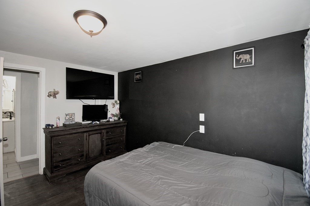 1617 Plumtree Road Springfield, MA 01119 - Photo 17 of 25 a bedroom with a bed and a flat screen tv