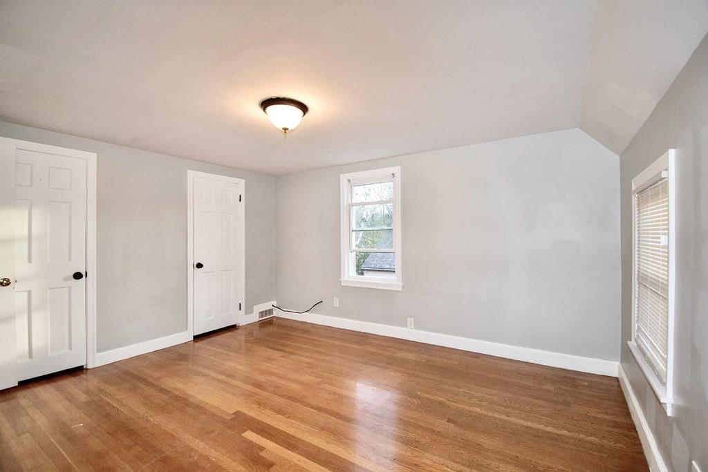 1617 Plumtree Road Springfield, MA 01119 - Photo 18 of 25 a view of an empty room with wooden floor and a window