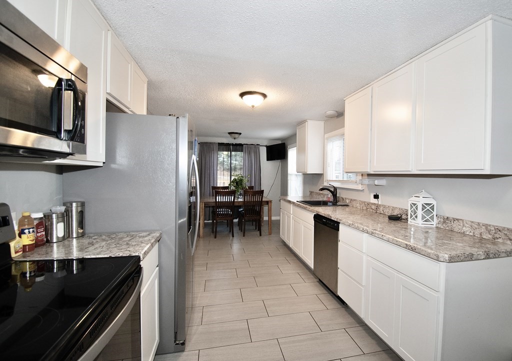 1617 Plumtree Road Springfield, MA 01119 - Photo 5 of 25 a kitchen with a sink cabinets and stainless steel appliances
