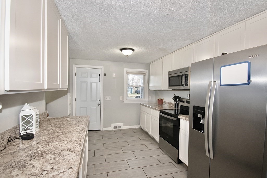 1617 Plumtree Road Springfield, MA 01119 - Photo 7 of 25 a kitchen with stainless steel appliances granite countertop a refrigerator and a sink
