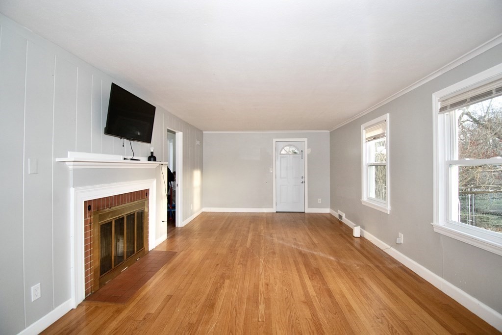 1617 Plumtree Road Springfield, MA 01119 - Photo 9 of 25 a view of empty room with fireplace and wooden floor