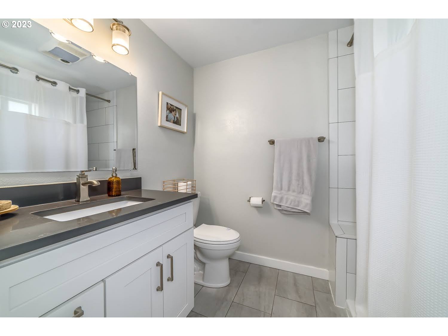 2478 15th Street Springfield, OR 97477 - Photo 15 of 29 a bathroom with a sink a toilet a mirror and shower