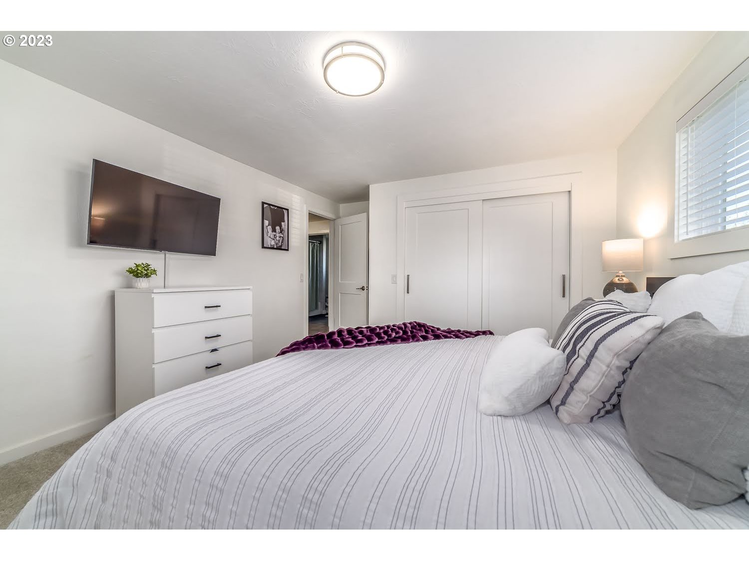 2478 15th Street Springfield, OR 97477 - Photo 17 of 29 a bedroom with a bed and a flat screen tv