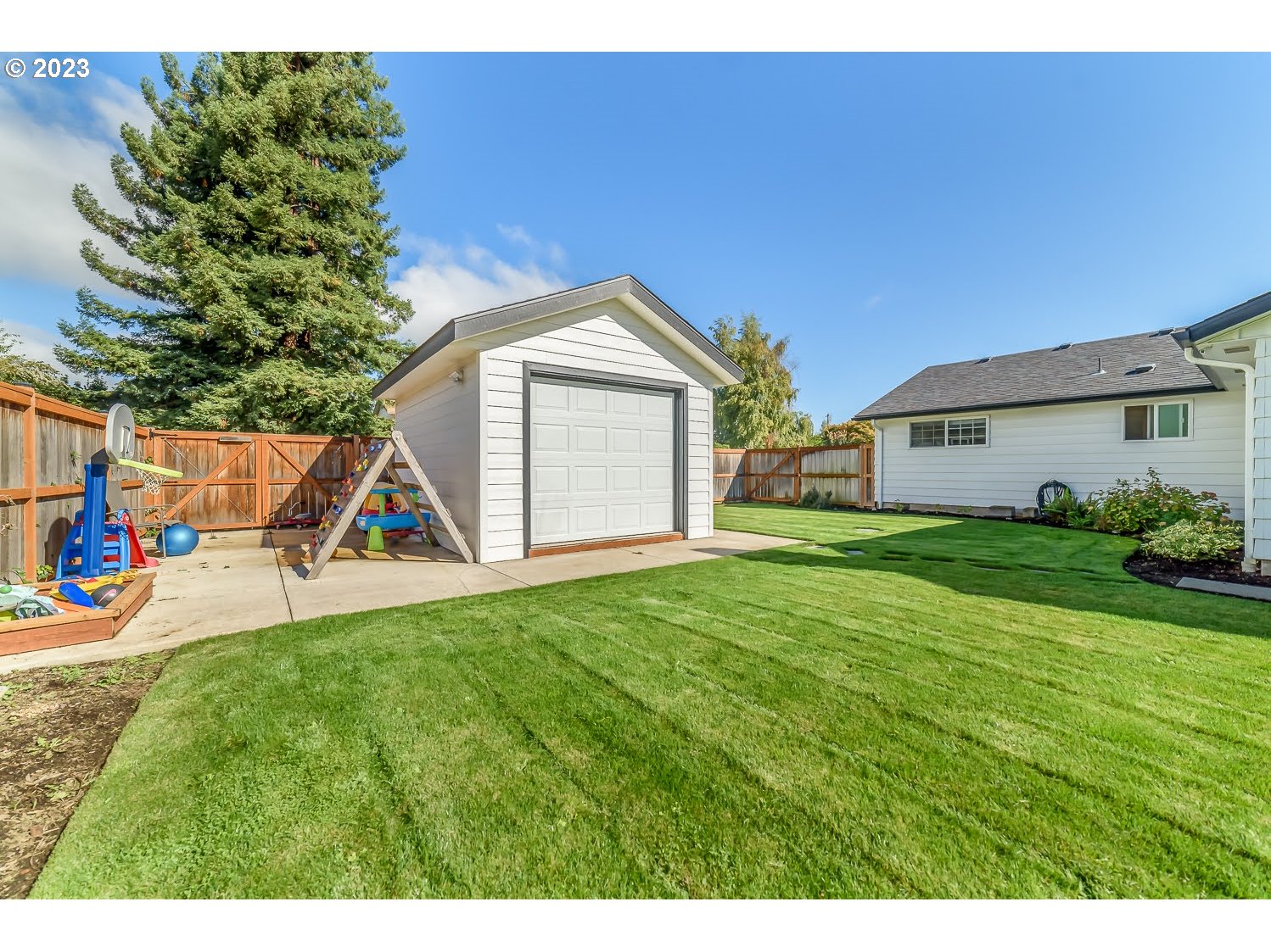 2478 15th Street Springfield, OR 97477 - Photo 29 of 29 a view of a house with backyard porch and garden