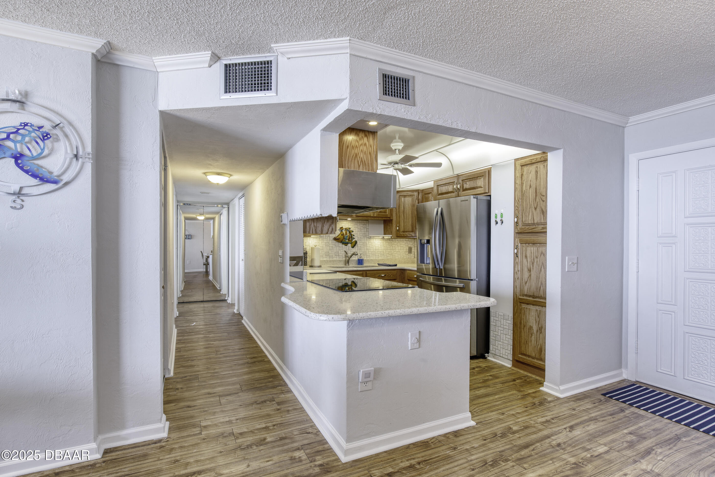 1415 Ocean Shore Boulevard, Unit 1010 Ormond Beach, FL 32176 - Photo 13 of 52 a large kitchen with stainless steel appliances granite countertop a large counter top and a wooden floors