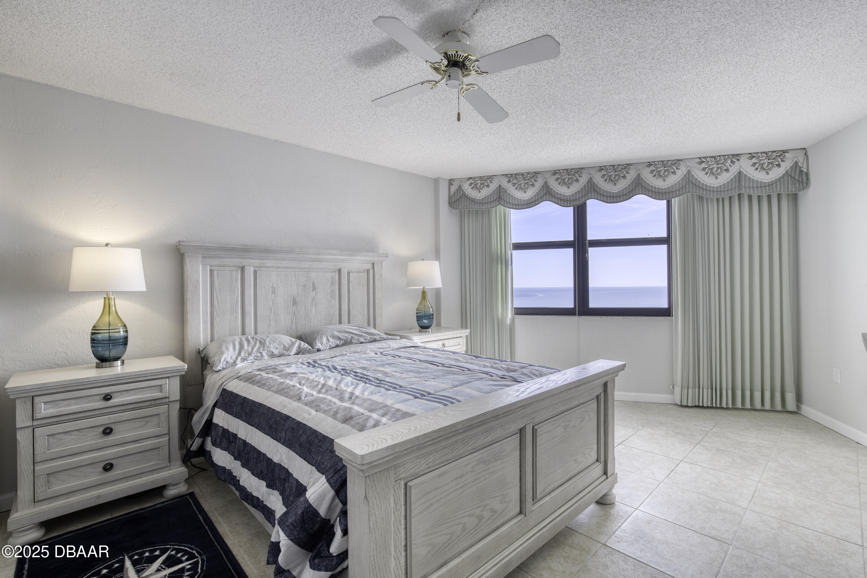1415 Ocean Shore Boulevard, Unit 1010 Ormond Beach, FL 32176 - Photo 16 of 52 a bedroom with a bed and a dresser