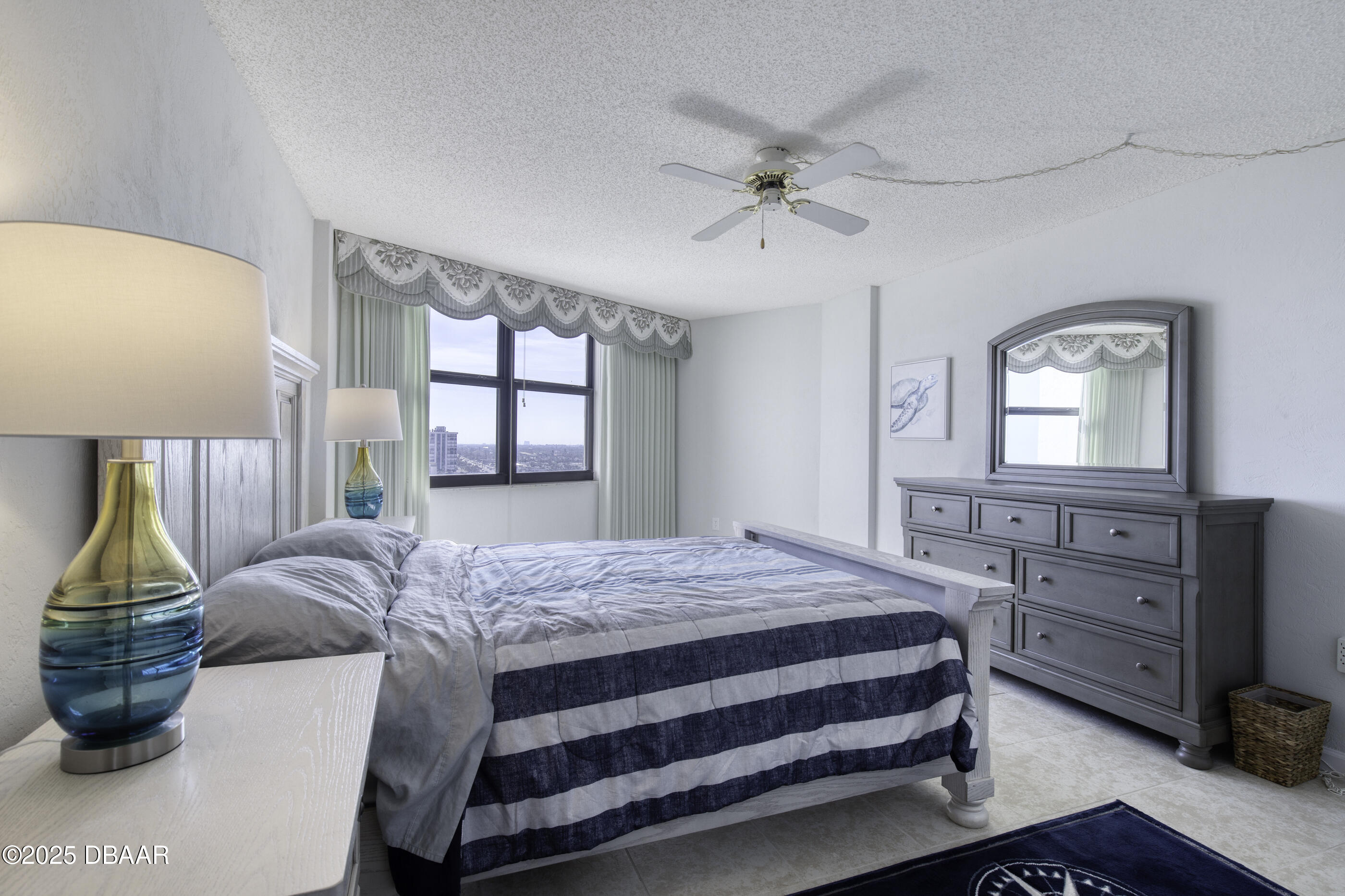 1415 Ocean Shore Boulevard, Unit 1010 Ormond Beach, FL 32176 - Photo 17 of 52 a bedroom with a large bed and a window