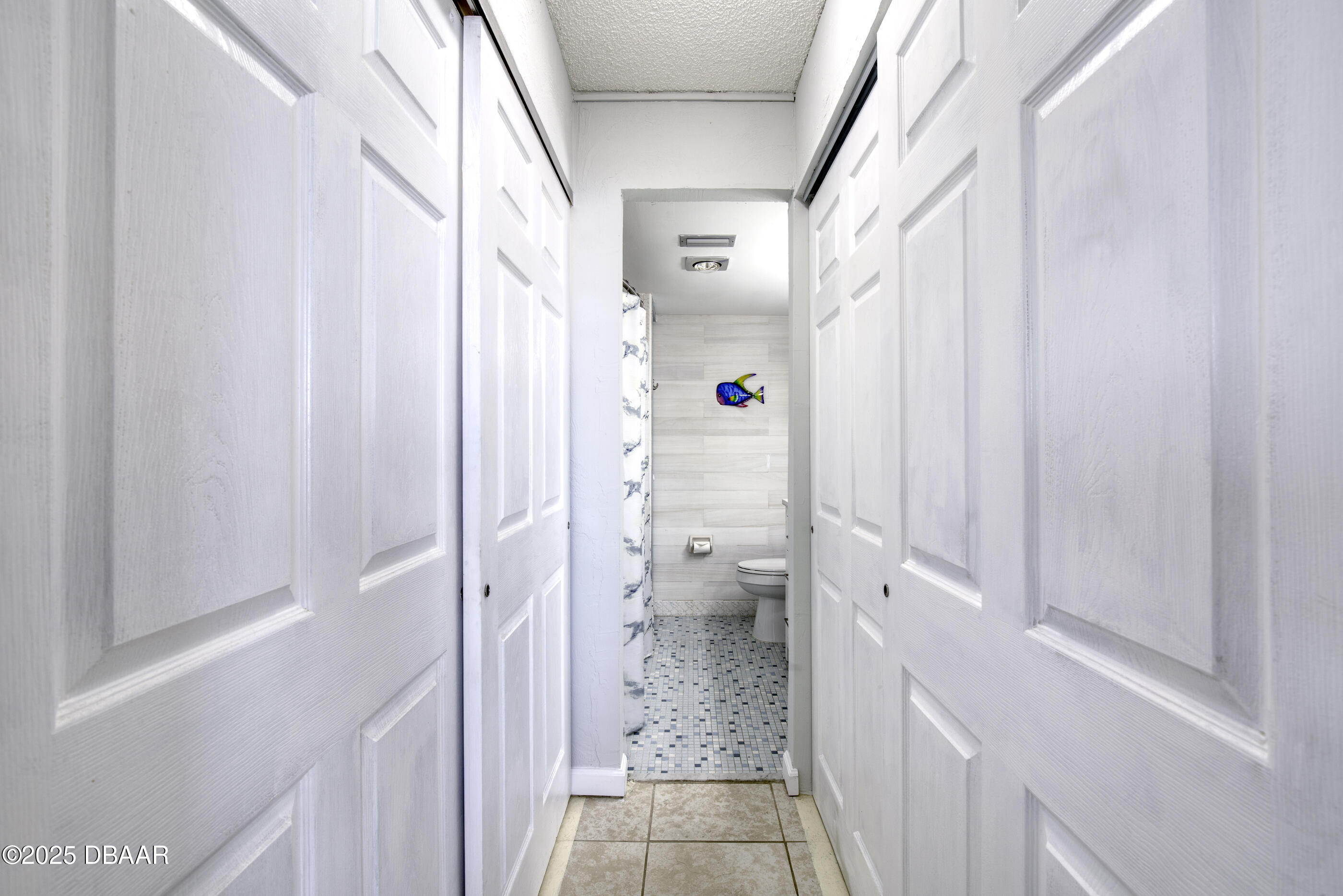 1415 Ocean Shore Boulevard, Unit 1010 Ormond Beach, FL 32176 - Photo 19 of 52 a bathroom with a granite countertop shower and a toilet