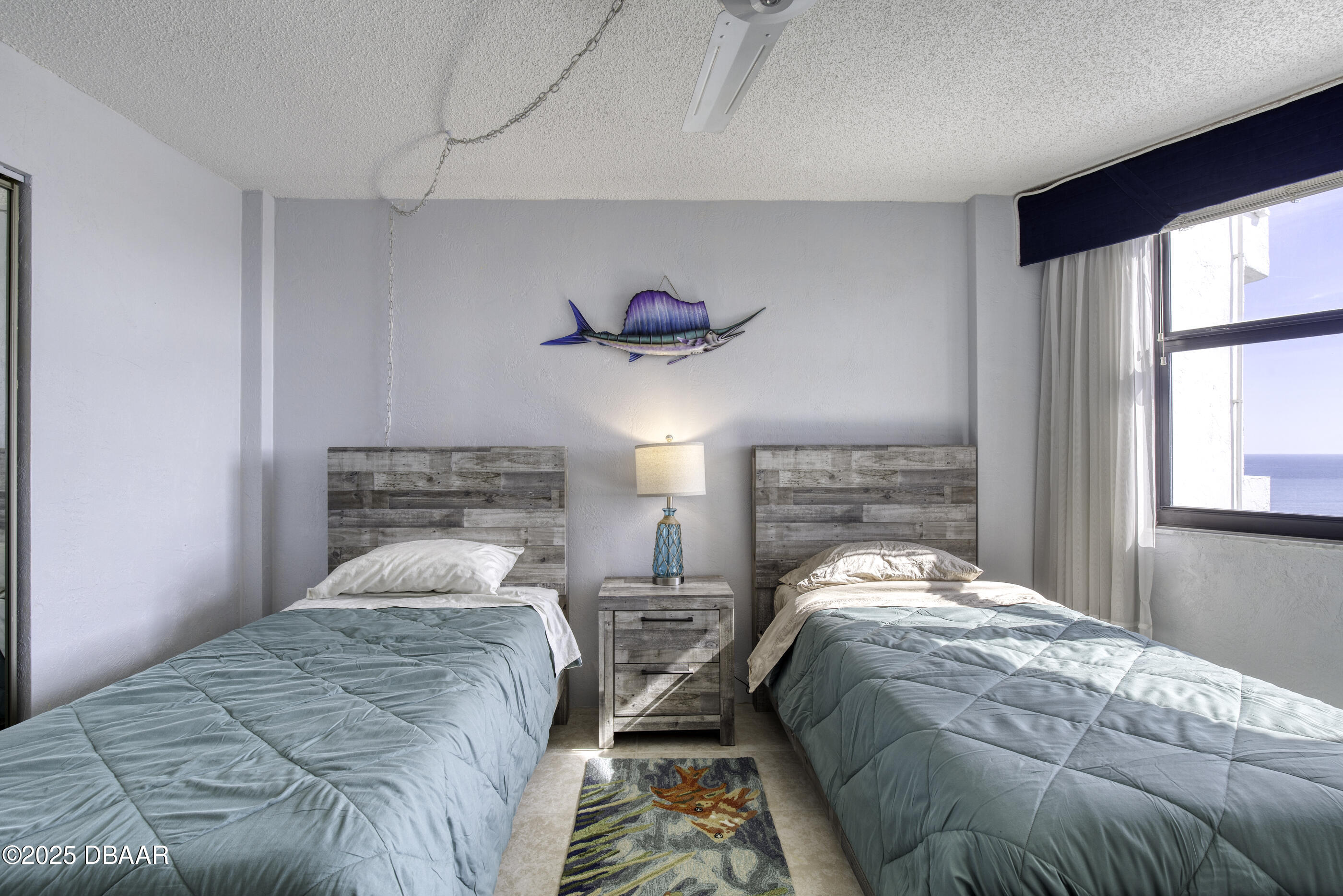 1415 Ocean Shore Boulevard, Unit 1010 Ormond Beach, FL 32176 - Photo 23 of 52 a bedroom with 2 bed and a window