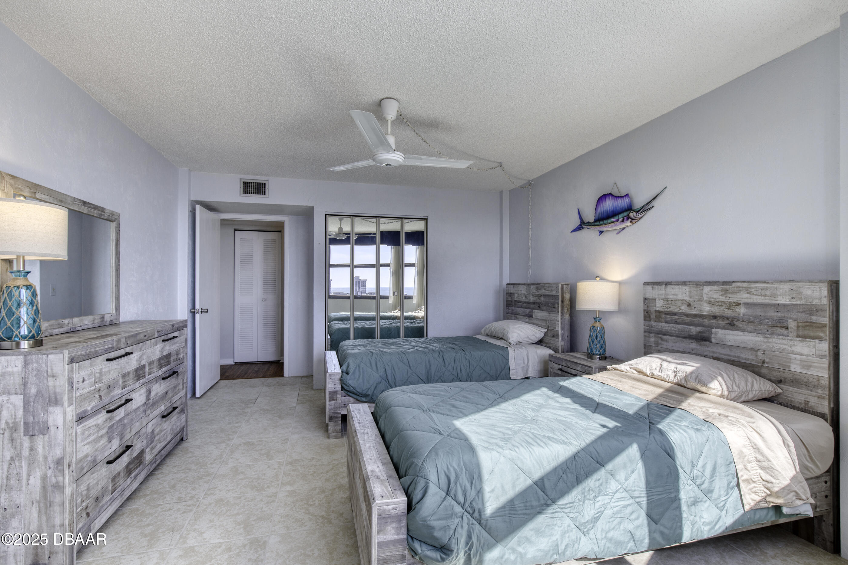 1415 Ocean Shore Boulevard, Unit 1010 Ormond Beach, FL 32176 - Photo 24 of 52 a bedroom with a bed and a dresser