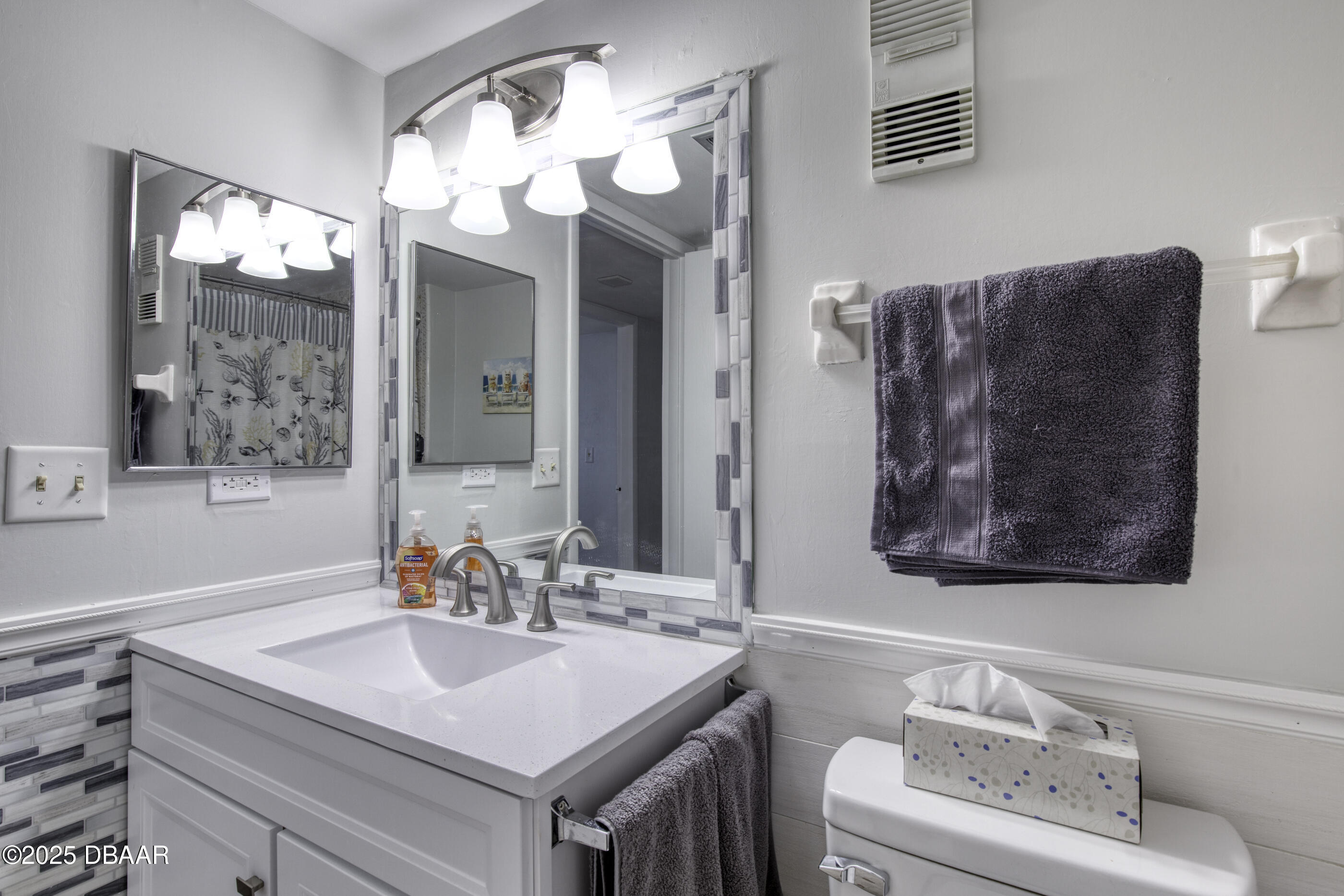 1415 Ocean Shore Boulevard, Unit 1010 Ormond Beach, FL 32176 - Photo 25 of 52 a bathroom with a sink vanity and a mirror