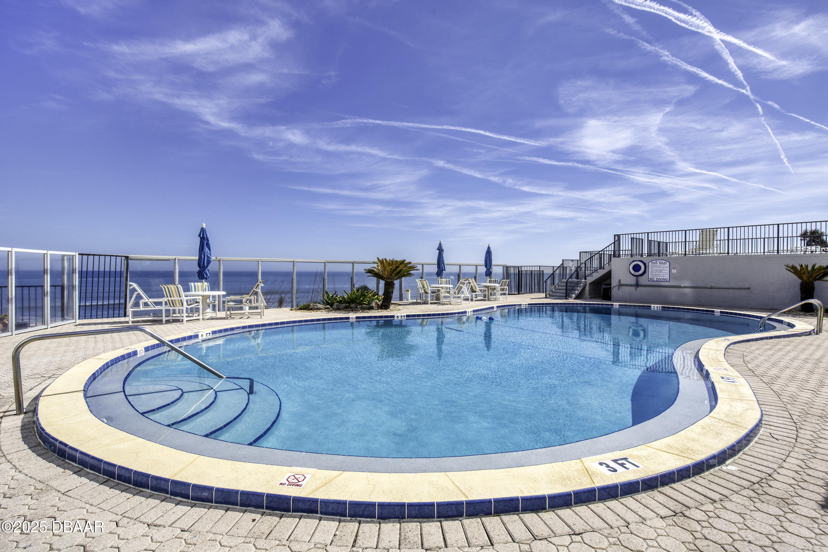 1415 Ocean Shore Boulevard, Unit 1010 Ormond Beach, FL 32176 - Photo 29 of 52 a view of a swimming pool with a lounge chair