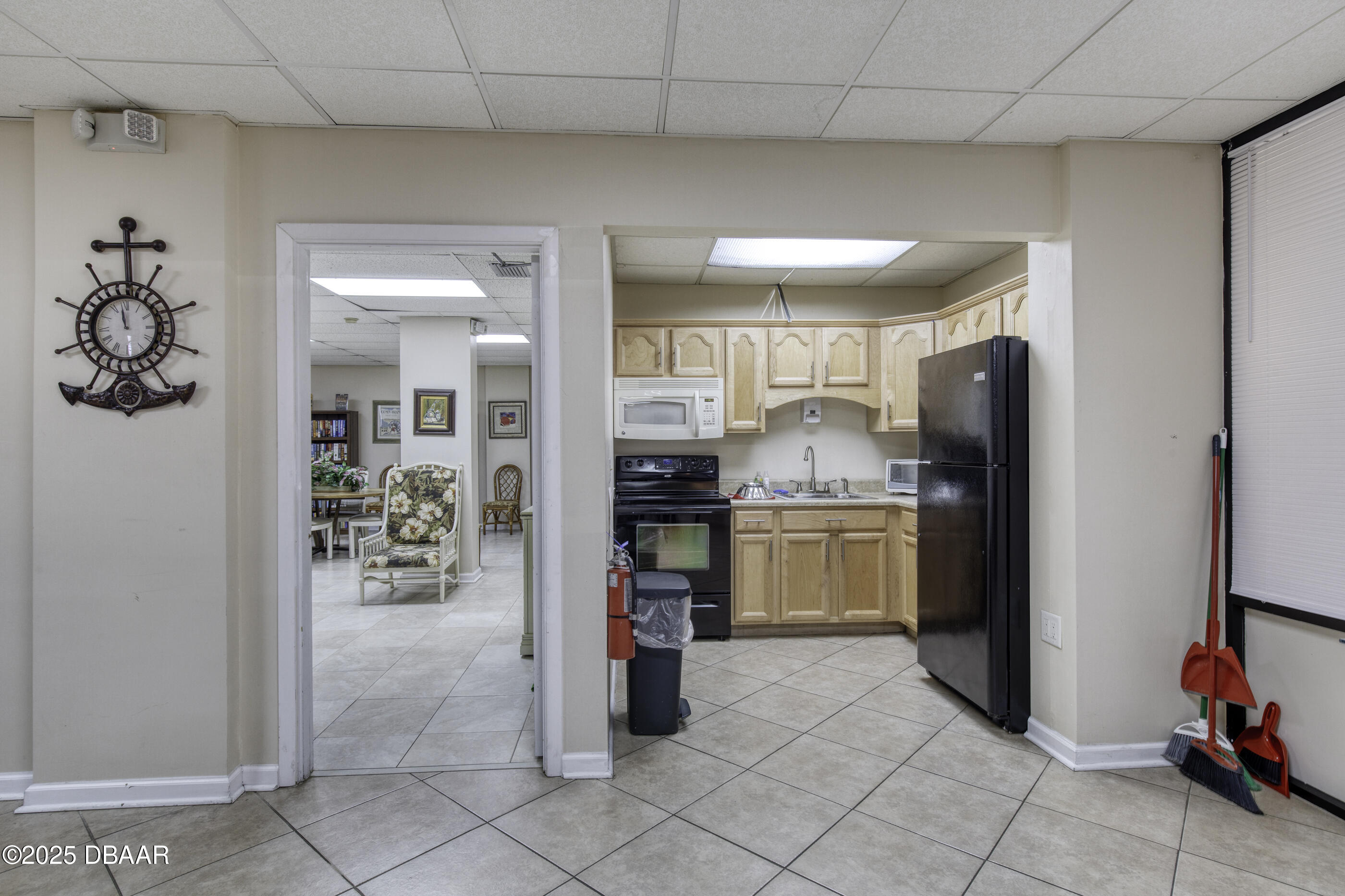 1415 Ocean Shore Boulevard, Unit 1010 Ormond Beach, FL 32176 - Photo 38 of 52 a kitchen with refrigerator and cabinets