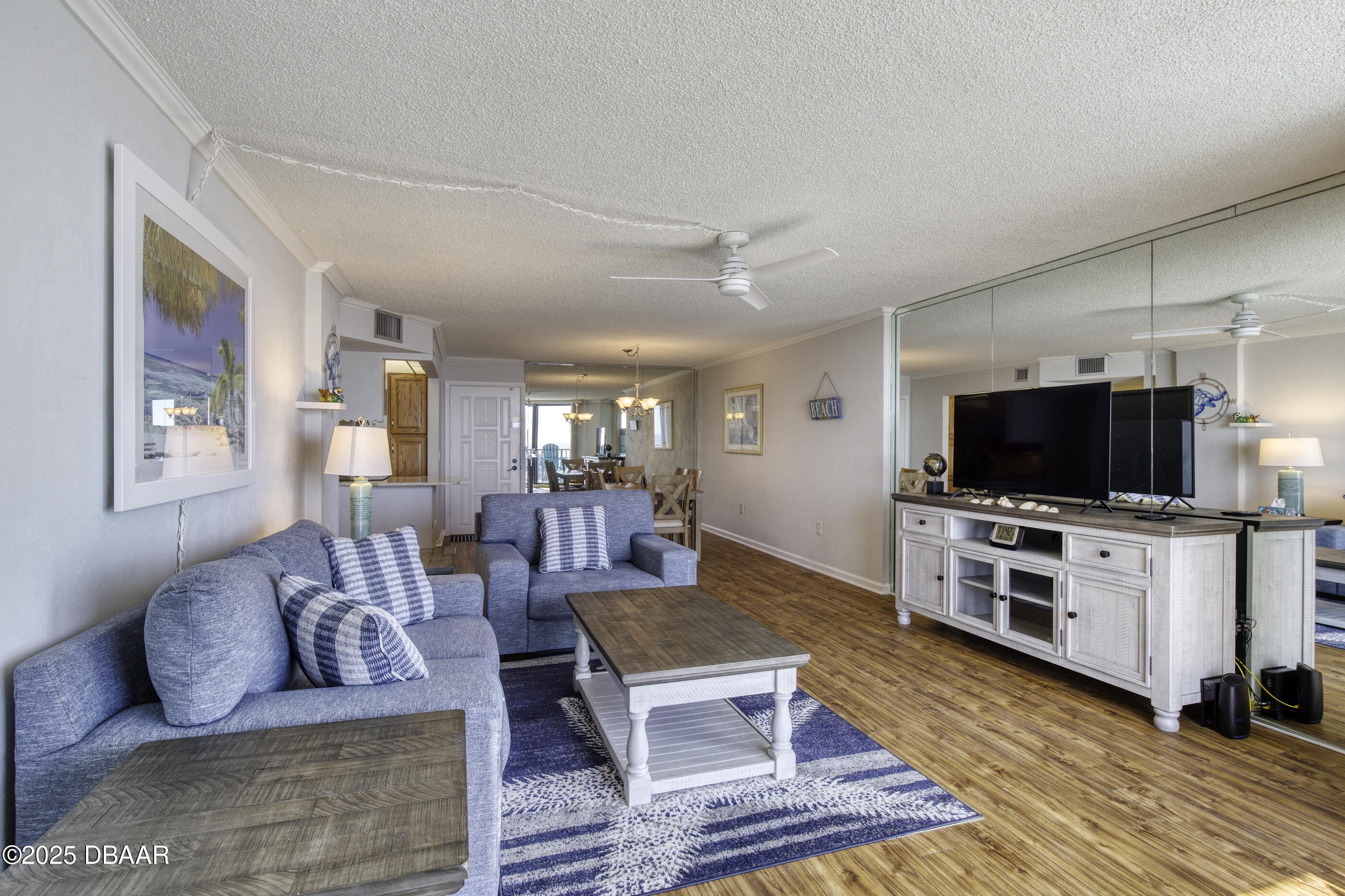 1415 Ocean Shore Boulevard, Unit 1010 Ormond Beach, FL 32176 - Photo 5 of 52 a living room with furniture and a flat screen tv
