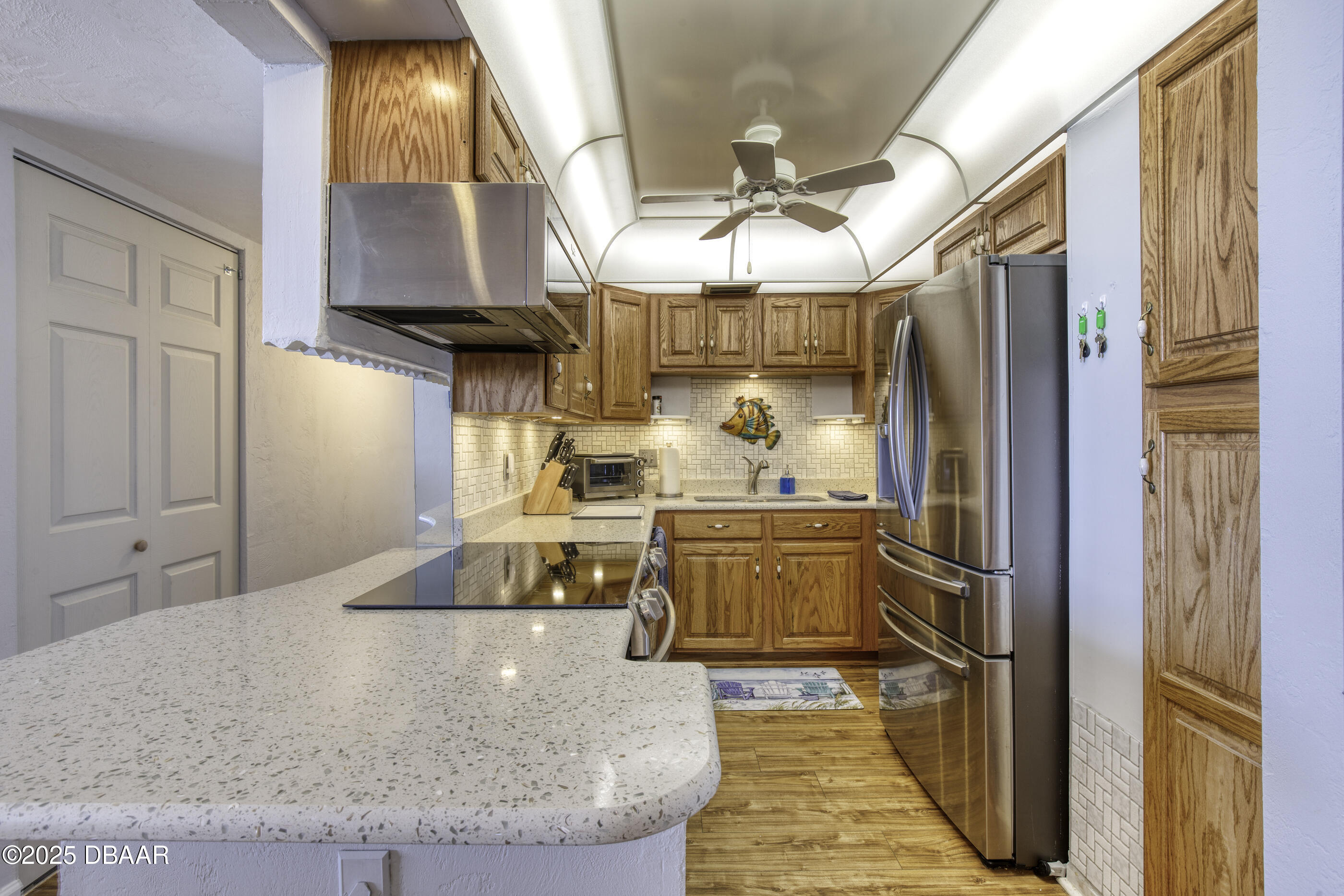1415 Ocean Shore Boulevard, Unit 1010 Ormond Beach, FL 32176 - Photo 7 of 52 a kitchen with stainless steel appliances granite countertop a sink stove and refrigerator