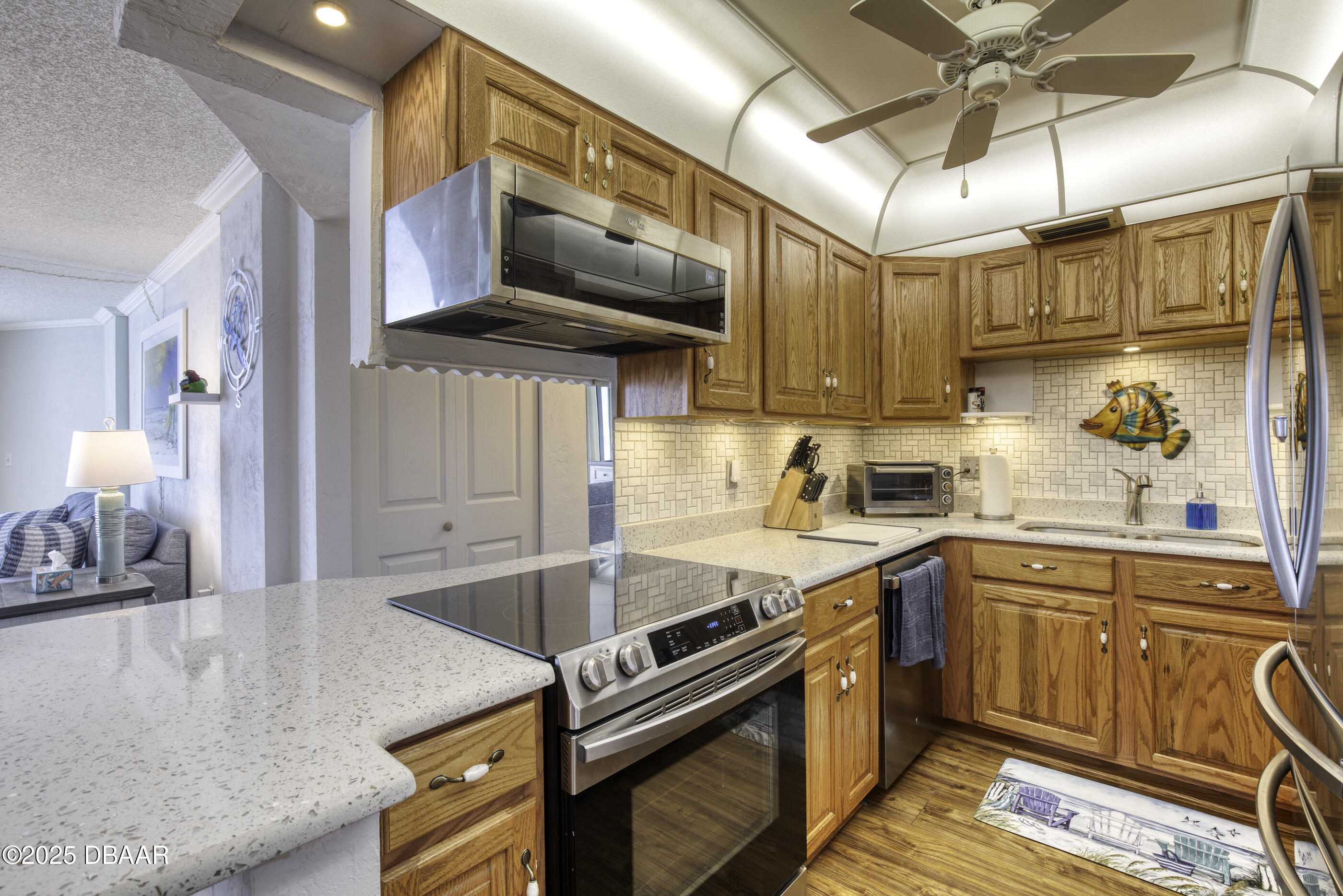 1415 Ocean Shore Boulevard, Unit 1010 Ormond Beach, FL 32176 - Photo 8 of 52 a kitchen with stainless steel appliances granite countertop a sink a stove and a microwave