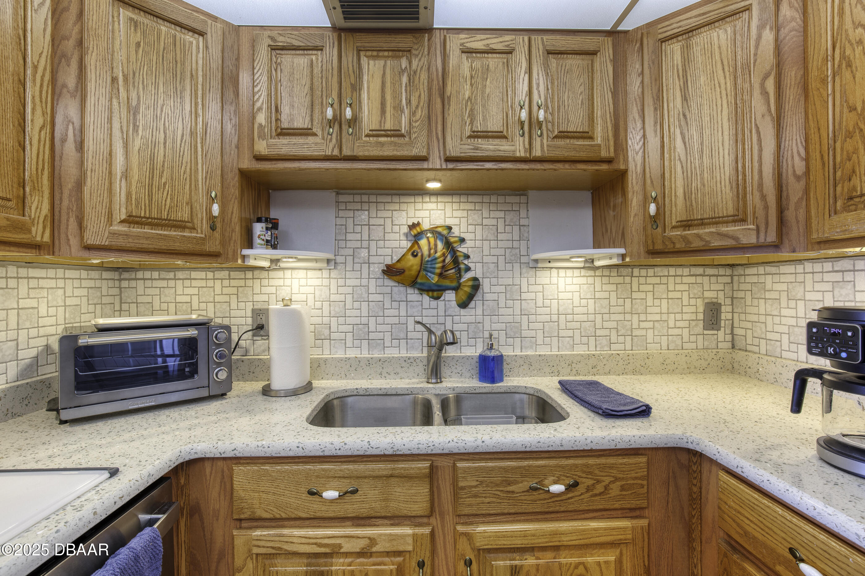 1415 Ocean Shore Boulevard, Unit 1010 Ormond Beach, FL 32176 - Photo 9 of 52 a kitchen with granite countertop a sink and a stove