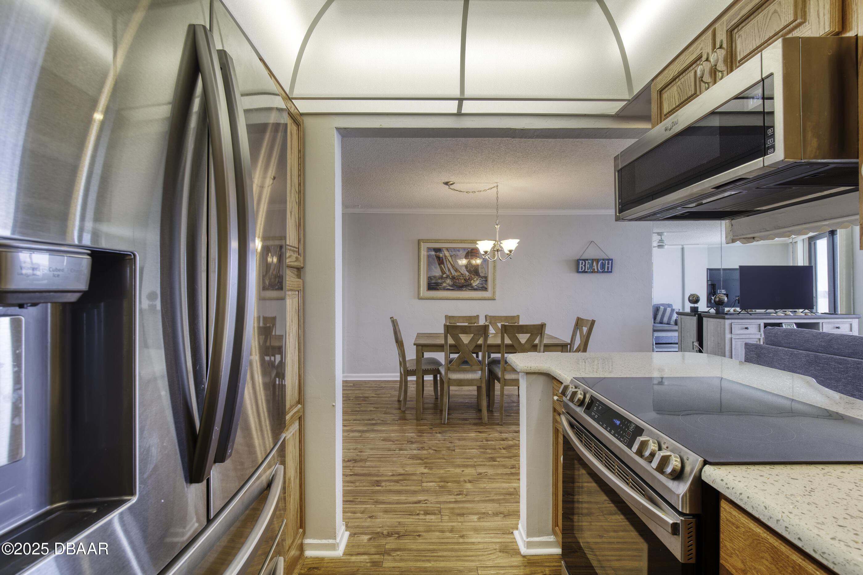 1415 Ocean Shore Boulevard, Unit 1010 Ormond Beach, FL 32176 - Photo 10 of 52 a kitchen with stainless steel appliances granite countertop a sink a stove and a refrigerator