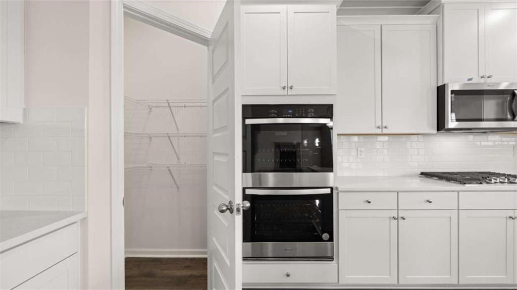 1912 Endress Circle Hampton, GA 30228 - Photo 14 of 43 a kitchen with stainless steel appliances white cabinets and a stove