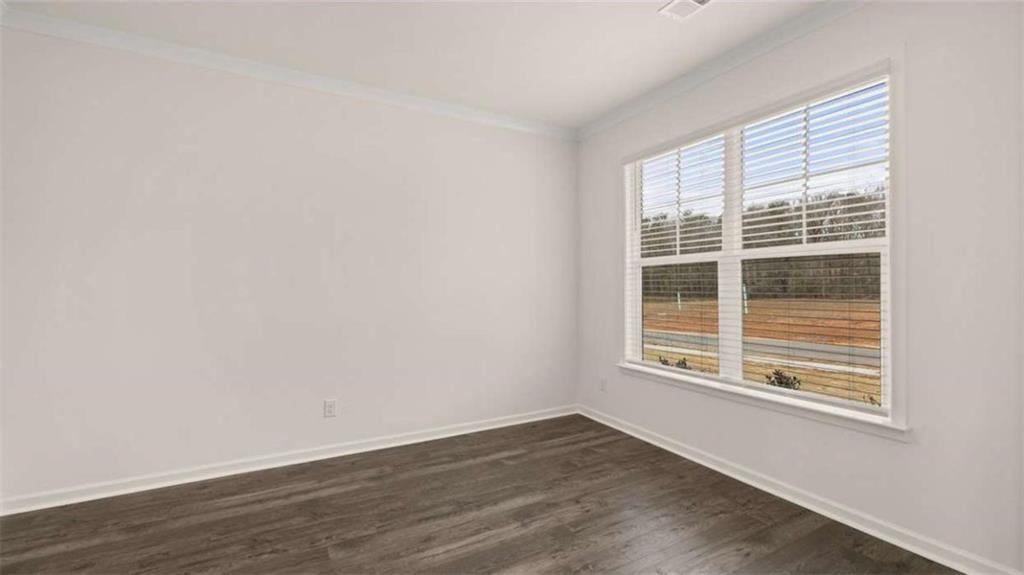 1912 Endress Circle Hampton, GA 30228 - Photo 4 of 43 a view of an empty room with wooden floor and a window