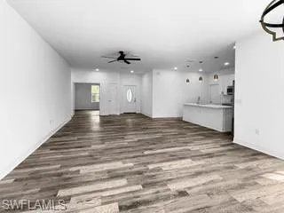 a view of an empty room with a kitchen