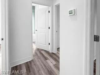 a view of a hallway with wooden floor
