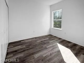 a view of wooden floor and windows in a room