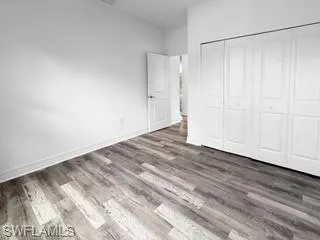 a view of a room with wooden floor