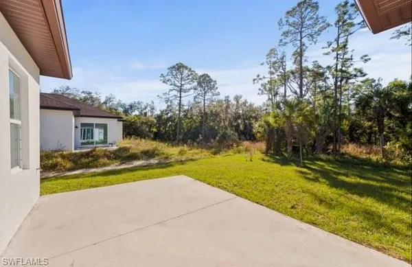 a view of house with backyard and swimming pool