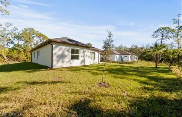 a house view with swimming pool in front of it