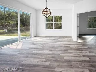 a view of wooden floor and windows in a room