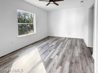 a view of a room with wooden floor and window